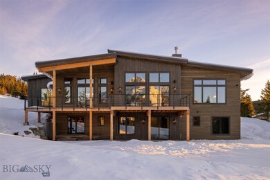 Front of home with Lone Peak reflection in living