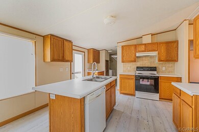 Kitchen featuring white appliances, sink, a kitche