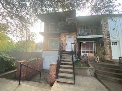 View of front of house with a balcony and brick siding
