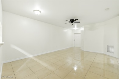 Spare room with ceiling fan, light tile patterned