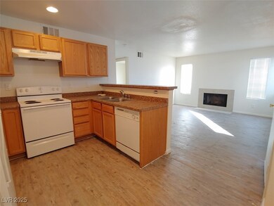 Kitchen featuring white appliances, light hardwood