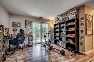 Workout area featuring a textured ceiling and hard