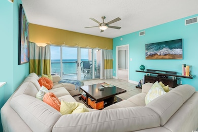 Tiled living room featuring ceiling fan, a textured ceiling, and baseboards