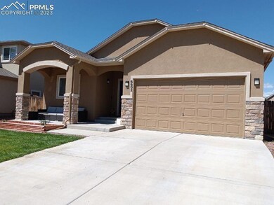Stucco and stone exterior with a covered front por