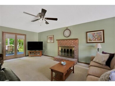 Large family room with brick fireplace, ceiling fa