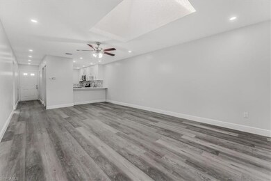 Unfurnished living room with recessed lighting, a ceiling fan, wood finished floors, and a skylight