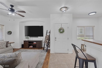 Living area with ceiling fan and healthy amount of natural light