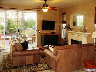 family room with fireplace steps out to the pool