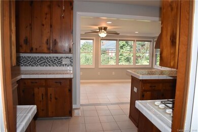 This kitchen has original knotty pine cabinets, lo