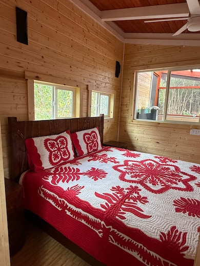 BEDROOM HAS AN ARTISTIC TONGUE AND GROOVE INTERIOR WHICH ACCENTUATES THE TRADITIONAL HAWAIIAN QUILT BED COVER!