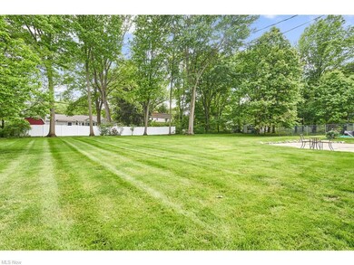 This 1/2 acre + lot boasts a large, level backyard