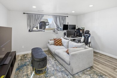 Living room featuring recessed lighting, wood finished floors, and a desk