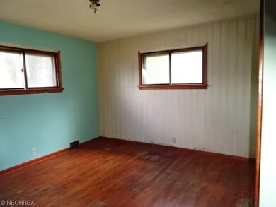 bedroom 1 on first floor with hardwood floors