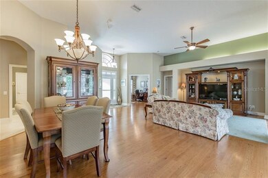 Open floorplan with gleaming hardwood floors and 1