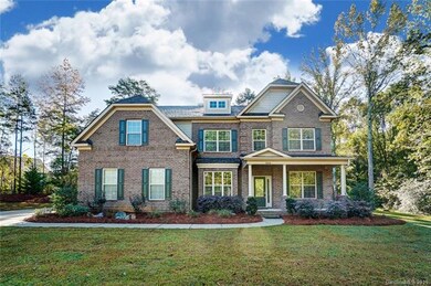 Brick beauty with covered rocking chair front porc