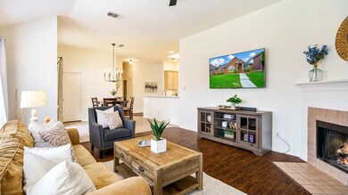 Living room with wood-type flooring, a chandelier,
