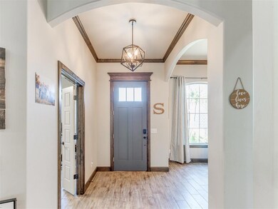 Foyer entrance with crown molding, light wood-styl
