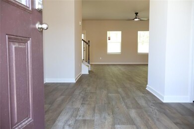 Foyer featuring wood finished floors, baseboards, 