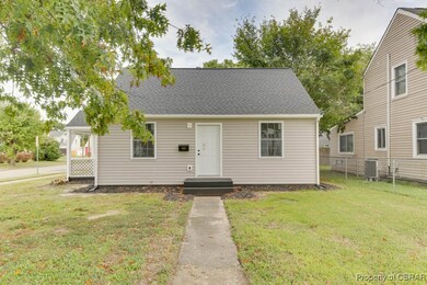 Bungalow-style home featuring a front lawn and cen