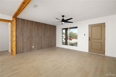 Unfurnished living room with visible vents, light wood finished floors, and a ceiling fan
