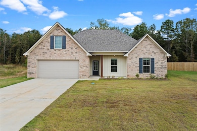 Traditional-style house with driveway, board and batten siding, and brick siding