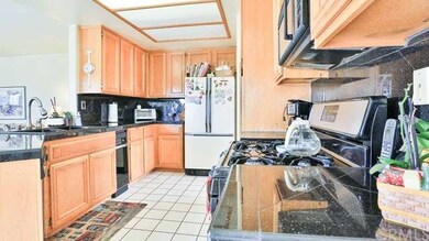 Kitchen view with upgraded granite counter tops ti