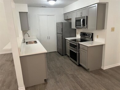 Kitchen featuring stainless steel appliances, gray