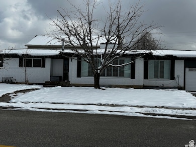 View of front of house featuring brick siding and an attached garage