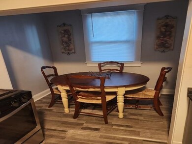 Dining room featuring wood finished floors and bas