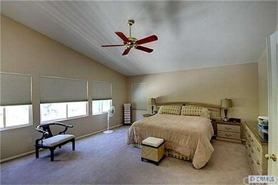 Spacious master bedroom with ceiling fan