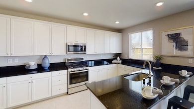 The multifunctional kitchen features granite or quartz countertops, brand new stainless steel applia