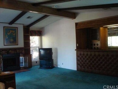 Large family room with stone fireplace and wet bar