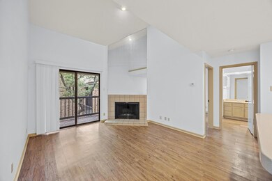 Unfurnished living room featuring baseboards, lig