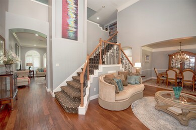 Upon entering the home you are greeted with a stunning view of the formal living and formal dining, as well as a glimpse into the family room.  Gorgeous Acacia hardwood flooring, crown molding and 6-in. baseboards flow throughout the first floor.  A double staircase leads up the upstairs game room, flex room and bedrooms.