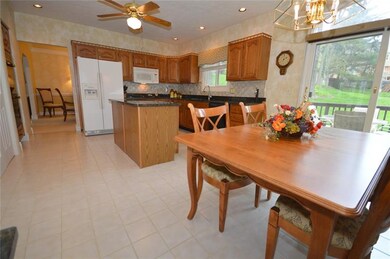 Cook's friendly kitchen features oak cabinets, cer