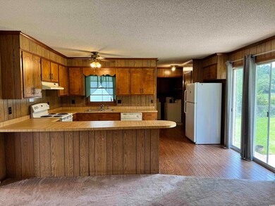 Kitchen featuring kitchen peninsula, white applian