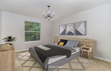 staged Bedroom with an inviting chandelier and lig