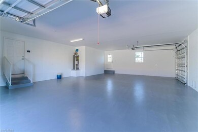 Garage featuring a garage door opener and water heater