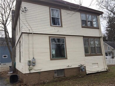 Rear of the house with parking spaces and stone dr