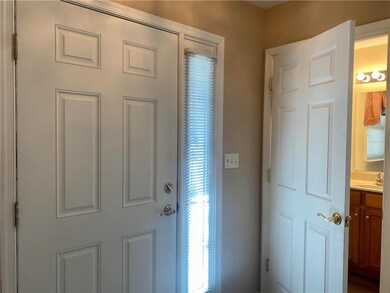 Foyer with coat closet and half bath.