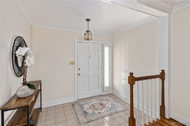 The Foyer entrance features crown moulding and a c