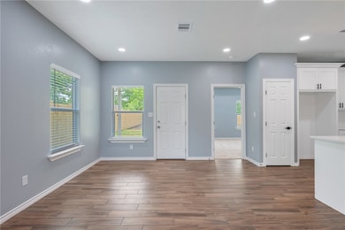 Unfurnished living room with dark wood-style floor