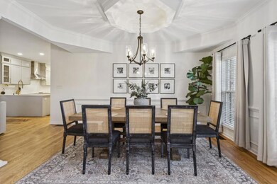 Formal Dining Room with Wainscoting Walls that seamlessly flows into the Fireside Family Room