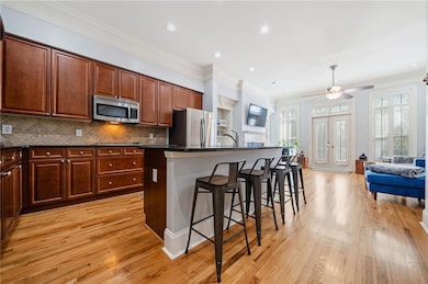 Kitchen featuring wood flooring, an island with si