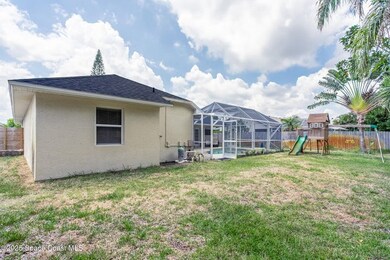 Rear view of house featuring a playground, a fenced backyard, a sunroom, and stucco siding
