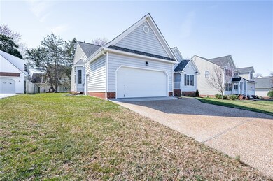 Single story home with a garage and a front lawn