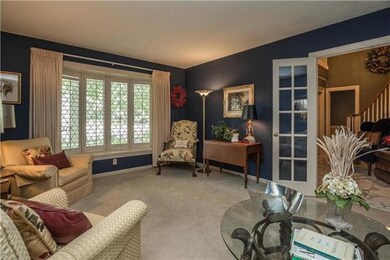 Living Room features leaded glass bay window and quietly enclosed behind beautiful french doors.