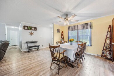 Dining space with ceiling fan, light wood-type flo