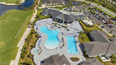 Drone / aerial view of a pool area and a large body of water