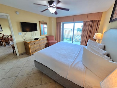 Bedroom featuring access to exterior, light tile p